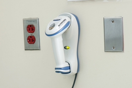 A barcode scanner mounted to a wall at UVA Hospital