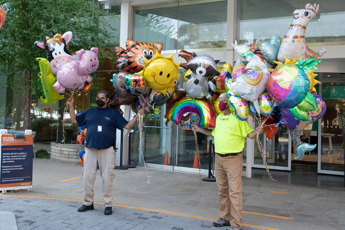 Evan Baldino and Tim Gilmer delivering balloons