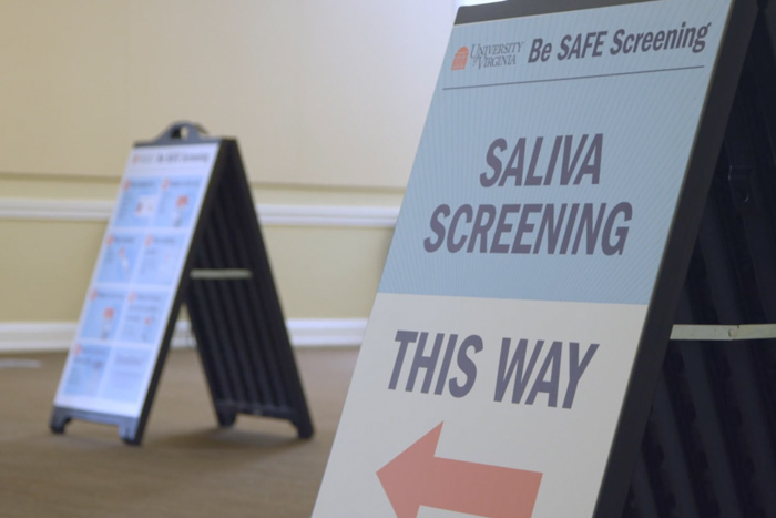 Signage reading 'Saliva Screening, This Way'