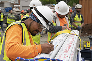 Construction workers signing the beam