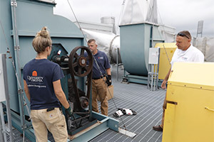Employees perform preventive maintenance on the Chemistry Building laboratories’ rooftop ventilation exhaust system.