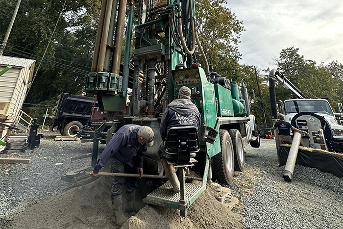 Energy & Utilities employees shoveling sediment